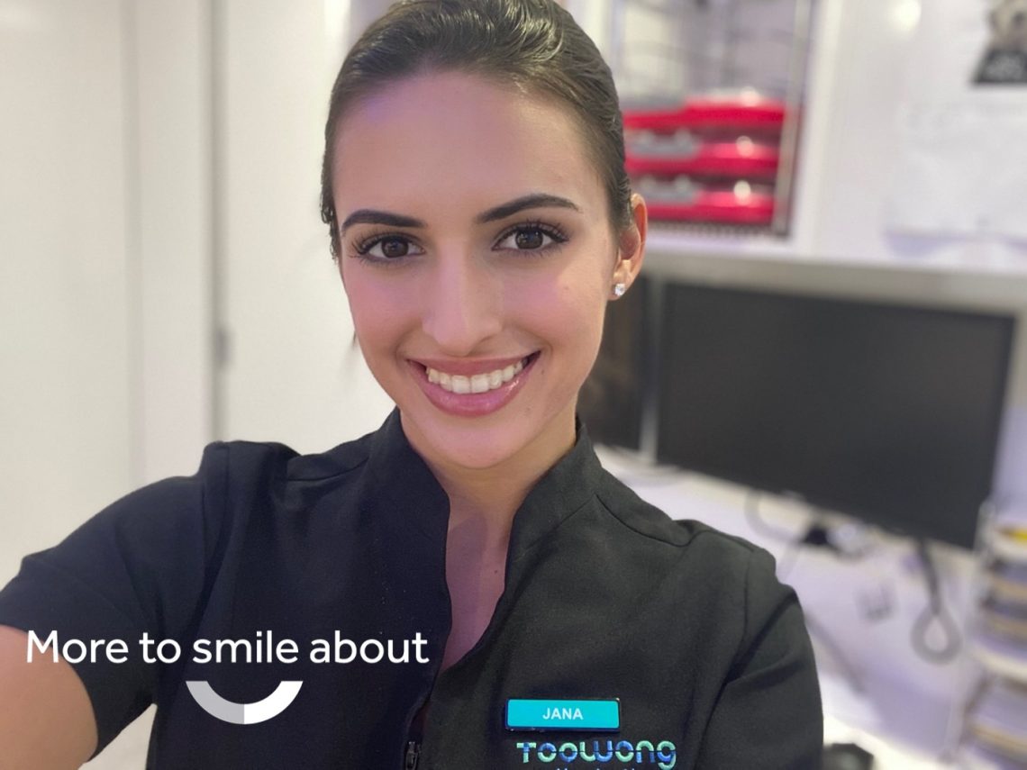 Woman with straight and white smile after Invisalign for adults treatment